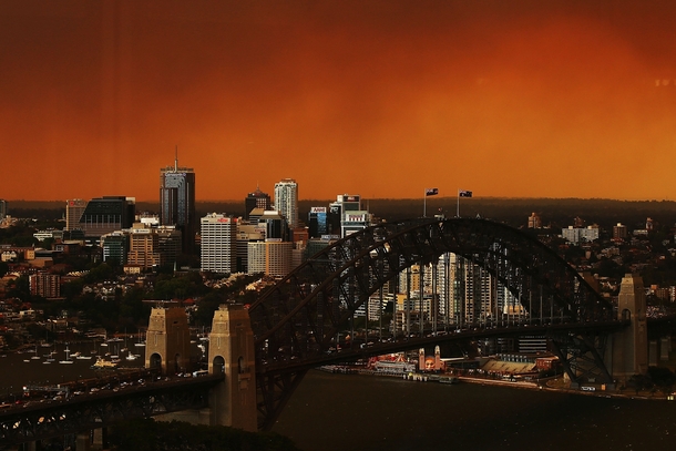 With dozens of wildfires raging outside the city an orange haze descended on Sydney today 