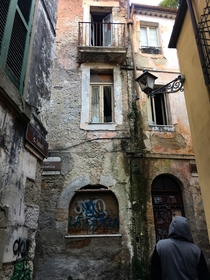  an old tv peeking out from the central window of this abandoned building in Sora Italy