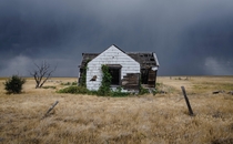  Storm a-brewin over an old farmhouse outside New Raymer Colorado