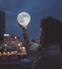  Took a photo of my friend holding the moon