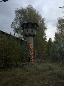 A B Tower German B-Turm short for Beobachtungsturm was a type of watchtower used by the East German Border Guards With inspection hatches and loopholes There was a swiveling searchlight on the roof which could be controlled by a remote control More than  