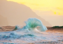 A breaking wave aglow in Kauai Hawaii Lace Andersen 