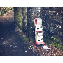 a childrens toy ball machine strangely abandoned by an old railway bridge in the woods still full of stuffed balls giggedy Those things are damn heavy usually seen in supermarkets to distract bored children its sighting in the woods is a mystery Balls fou