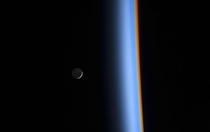 A crescent moon and the earths atmosphere taken from the ISS Feb st  