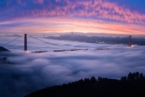 A fiery sunrise over a foggy San Francisco