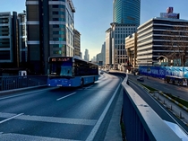 A gorgeous blue bus climbs over Bykdere Caddesi on a gorgeous blue day - stanbulEsentepe 