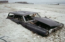 A half-buried early-s Dodge Polara station wagon on the beach in Queens New York  Photograph by Andy Blair