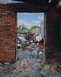 A hallway where people filled with life once walked sits charred and forgotten