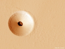 A Hole in Mars The hole about  meters across was discovered by chance in  on images of the dusty slopes of Mars Pavonis Mons volcano taken by theHiRISE instrument aboard the robotic Mars Reconnaissance Orbiter currently circling Mars