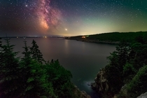 A humid hazy night and a setting Milky Way overlooking Hunters Beach in Acadia National Park Maine 