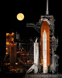 A nearly full Moon sets as the space shuttle Discovery sits atop Launch pad A at the Kennedy Space Center in Cape Canaveral Florida Wednesday March   Photo Credit NASABill Ingalls 