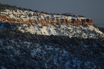 A partly snowy red rock ridge I saw while driving along Route  in southern Utah - 