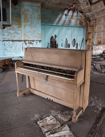 A piano left behind at an abandoned school 