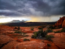 A rainstorm lit up by the setting sun at The Camelbacks aka The Vortex in Southern Utah 