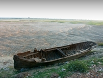 A riverboat hull lies on the dried up bank of the Ayeyarwady river near Mandalay 