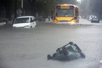 A school bus making waves on a flooded road in Norfolk Virginia Sept   