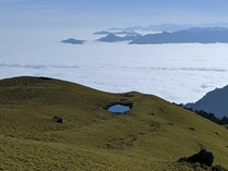 A small pond and a sea of clouds as a backdrop Mt Qilai East Ridge Taiwan 