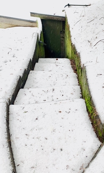 A staircase in the snow leading to an abandoned shed Crestline CA 