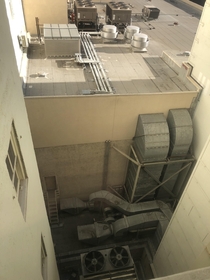 A trio of high-capacity upblast ventilators and chiller system serves a nearby subway system amidst this lowrises traditional HVAC needs