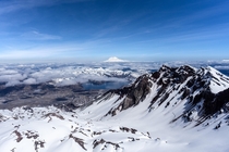 A view of Mount St Helens crater from the summit with Mount Rainer in the distance 