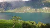 A view with a rainbow in Sunnylvsfjord leading into Geiranger Norway 