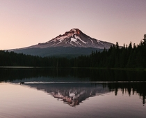 A warm summer sunset at Trillium lake with Mount Hood in the background 