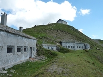 Abandoned barracks of the Italian border guard on Monte ElmoHelm on the border between Italy and Austria Behind them the equally abandoned Helmhaus mountain hut