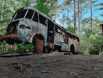 Abandoned bus in a graveyard for cars in southern Sweden 