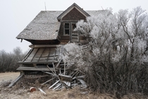 Abandoned Canadian farmhouse with frost 