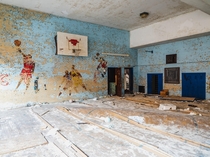 Abandoned Elementary Gym with a Basketball Mural