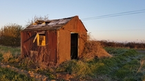 Abandoned farmers shack in todays frosty sunrise Cambridgeshire England