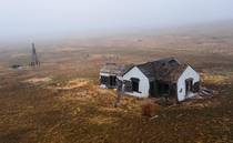 Abandoned farmhouse on a foggy morning New Raymer Colorado 
