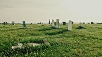 Abandoned graveyard off some cliffs overlooking the ocean in Nova Scotia