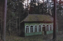 Abandoned house being slowly consumed by the forest It belongs to an old children summer camp in Lithuania not working since 