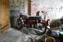 Abandoned motorcycle in old garage North Yorkshire England 