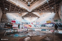 abandoned natatorium left to decay becomes a canvas for vandals