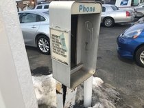 Abandoned payphone by gas station