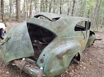 Abandoned Plymouth that can be seen along the trails of the pictures rocks national lakeshore It has hundreds of names carved into the body and the engine still in it More pictures in the comments
