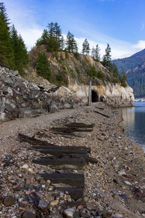 Abandoned rail line along the Columbia River now dammed into the Arrow Lakes Reservoir west of Castlegar BC 