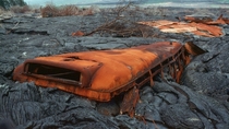Abandoned school bus engulfed in volcanic rock