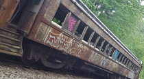 abandoned train in NH now painted black and boarded up