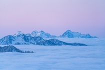Above the clouds for a  degree sunrise in the North Cascades of Washington state USA 