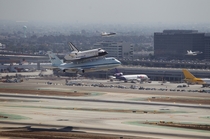 Accompanied by NASA FA- Hornet jets NASAs Space Shuttle Endeavour atop the Shuttle Carrier Aircraft or SCA performs a fly-by of Los Angeles International Airport on  September  in Los Angeles California United States of America Photographer Joel Kowsky NA