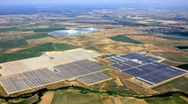 Aerial view of the unit I III and IV of Abengoa Solars Solnova Solar Power Station The two towers and reflective mirrors in the background are the PS and PS solar power plants 