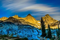 Alpenglo representing the calm before the storm on Ritter  and Banner  Peaks in Ansel Adams Wilderness California October  