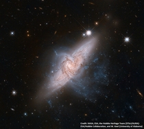 Amazing chance alignment between galaxies These two galaxies look as if they are colliding but they are actually separated by tens of millions of light-years or about ten times the distance between our Milky Way and the neighboring Andromeda galaxy Credit