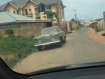 An abandoned and vintage  Mercedes-Benz  SEL quietly sitting at the corner of a road in Ibadan Nigeria