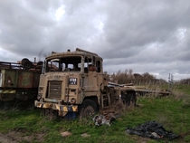 An abandoned army-truck hidden behind a burnt-out farmhouse in Leicester