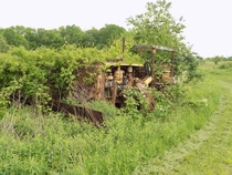 An abandoned bulldozer slowly being reclaimed by nature 