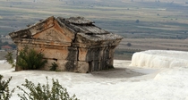 An abandoned Mausoleum submerged in a travertine pool at Hierapolis hot springs Turkey 